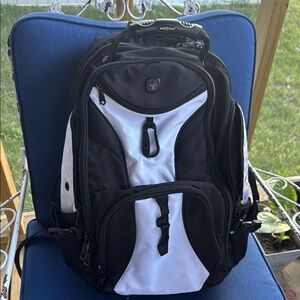 SwissGear Black and White Backpack one of the side strips is shorter